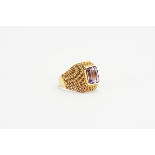 189 - A 18ct Gold Amethyst Ring resting on mesh shoulders. Size N. Weight: 6.6 grams.