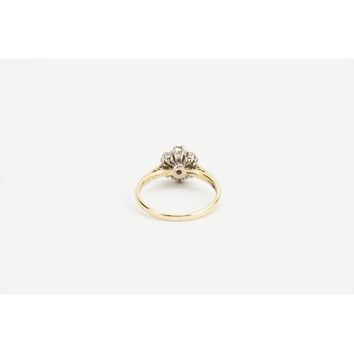 140 - An 18ct Gold Diamond Cluster Ring, set with 7 Diamonds in the daisy form. Largest Diamond: 0.15ct.We... 