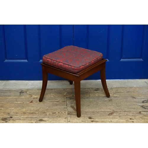 605 - A Mahogany Stool with Swept out Legs and a Squab Cushion.