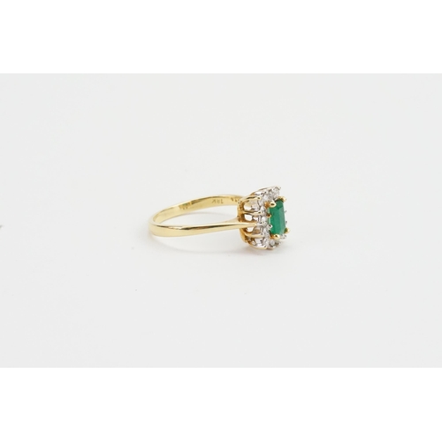 97 - An 18ct Gold Diamond & Emerald Set Ring, Emerald size: 4mms x 6.1mms. Weighing: 4.3 grams. Size: R.