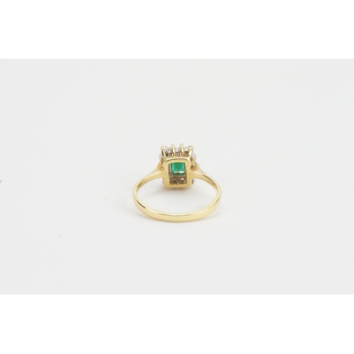 97 - An 18ct Gold Diamond & Emerald Set Ring, Emerald size: 4mms x 6.1mms. Weighing: 4.3 grams. Size: R.