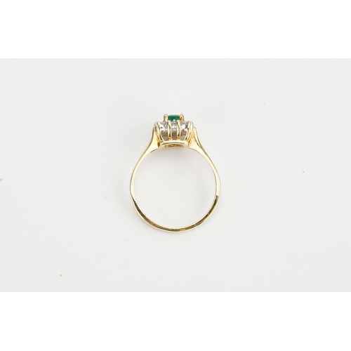 97 - An 18ct Gold Diamond & Emerald Set Ring, Emerald size: 4mms x 6.1mms. Weighing: 4.3 grams. Size: R.