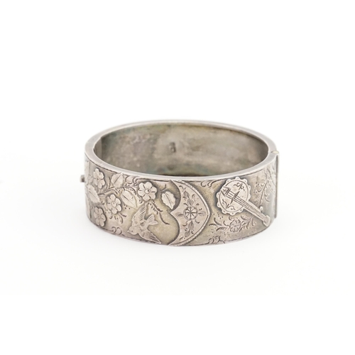 102 - A Victorian engraved Silver Bangle. Weighing: 25 grams.