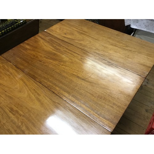 602 - A Georgian Mahogany Twin Pillared Dining Table Resting on Fluted Legs with Brass Castors, fitted wit... 