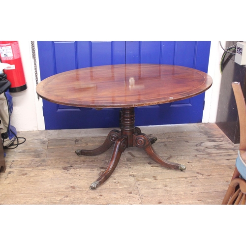 582 - An Oval Topped Regency Designed Fold Over Topped Dining Table with Cross Banding & Pad Feet. Measuri... 