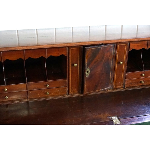 587 - A Georgian Mahogany Drop-Flap Bureau fitted with graduated Drawers, Pull Out Brush in Slide, Brass H... 