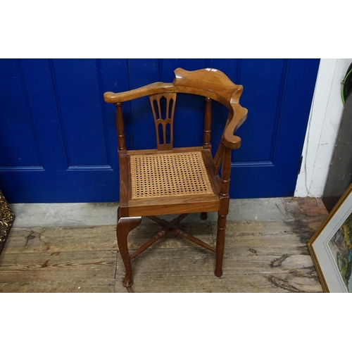 605 - An Edwardian Splat Back Corner Chair in Walnut with Bergere Seat resting on Pad Feet.