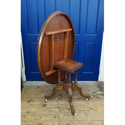 636 - A Victorian Design Fold Over Top Loo Table resting on a carved base with a later finish. Measuring: ... 