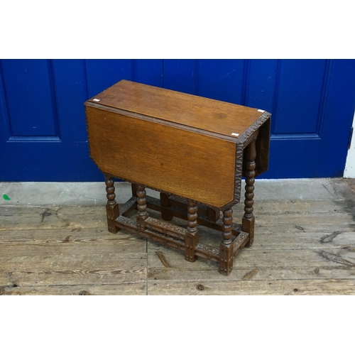 644 - A Late 19th Century Carved Oak Jacobean Revival Drop-Flap Gate Leg Table with a carved base, bobbin ... 