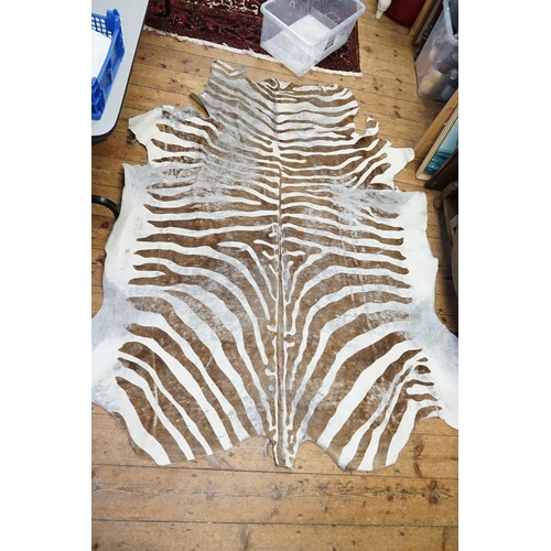 658 - A Dyed brown & white animal Skin Rug.