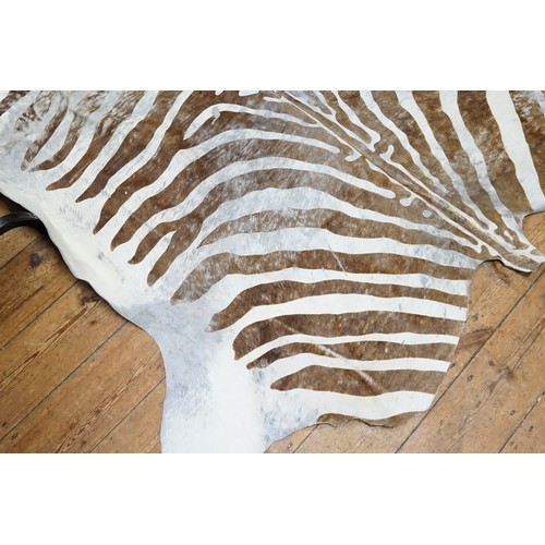 658 - A Dyed brown & white animal Skin Rug.