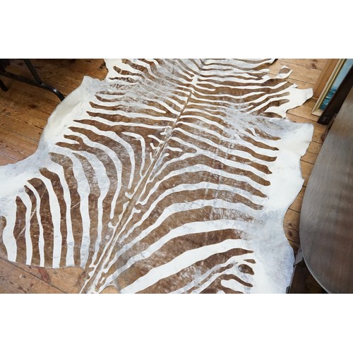 658 - A Dyed brown & white animal Skin Rug.