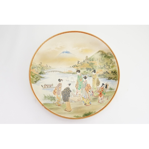 765 - A Large Kyoto Dish decorated with Mount Fuji & attendant Ladies. Measuring: 46cms.