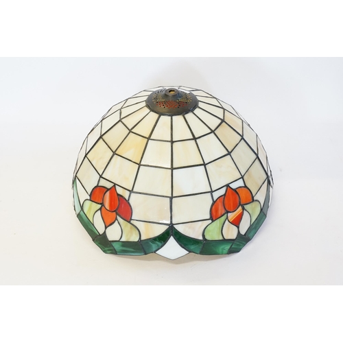 670 - A Tiffany design light shade, with floral decoration.