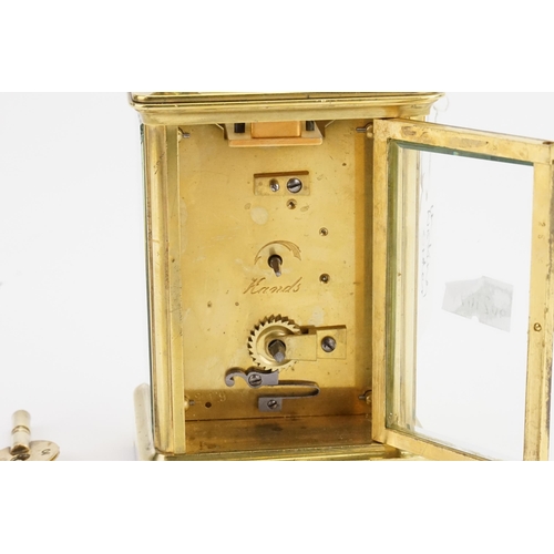 320 - A Brass Cased Four Plate Carriage Clock with Visible Escapement, Swing Handle with Original Receipt ... 