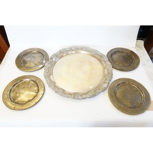 704 - An Indian Grape decorated Tea Tray & Four Heavy Steel & Brass mounted Rope decorated Plates.