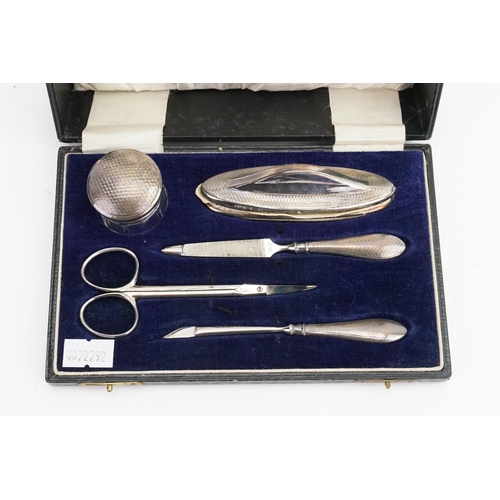 9 - A Silver and steel dressing table set in original case.