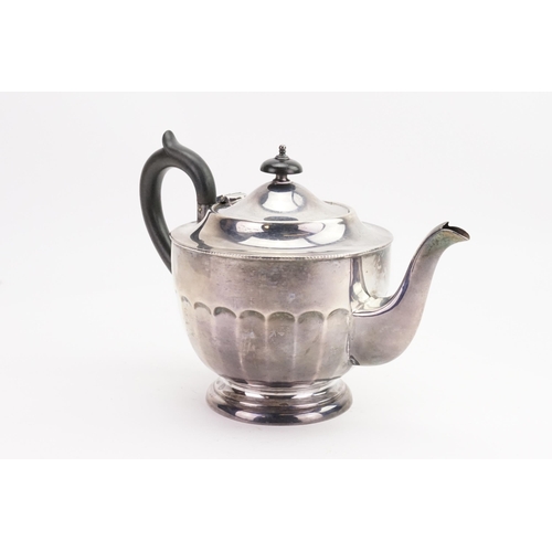 52 - A Sheffield 1933 Silver tea pot, with carved ebony handle. Maker Viners Ltd (Emily Viner). Weight 48... 