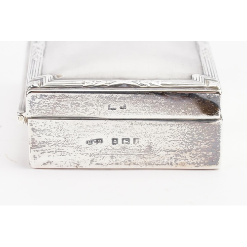 86 - A Rectangular Silver Rib & Edged Cigarette Box with a Cavachon Thumb Piece.