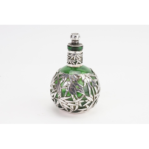 746 - A Chinese Silver mounted Bamboo decorated Cologne Bottle with Stopper. Measuring 10cms High.