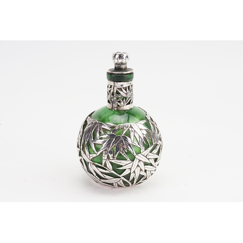 746 - A Chinese Silver mounted Bamboo decorated Cologne Bottle with Stopper. Measuring 10cms High.