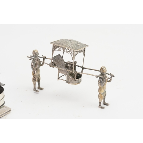 747 - A Chinese Silver Pepperette designed as a Pagoda along with three similar figures of a Palanquin car... 