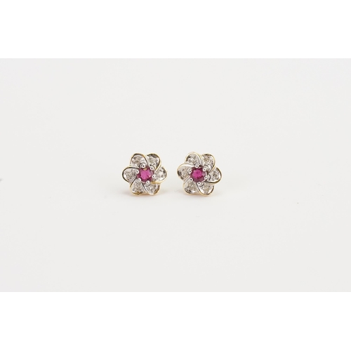 165 - A pair of Diamond and Ruby set flower earrings. Weight: 2.4g. Sapphire size approx. 0.18ct.