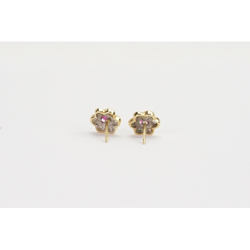 165 - A pair of Diamond and Ruby set flower earrings. Weight: 2.4g. Sapphire size approx. 0.18ct.