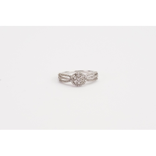 183 - A 9ct white Gold diamond set floral design ring. Weight 2.4g. Size Q.