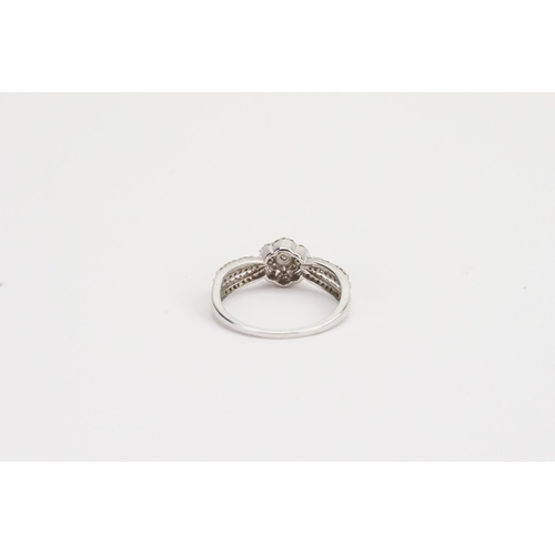 183 - A 9ct white Gold diamond set floral design ring. Weight 2.4g. Size Q.