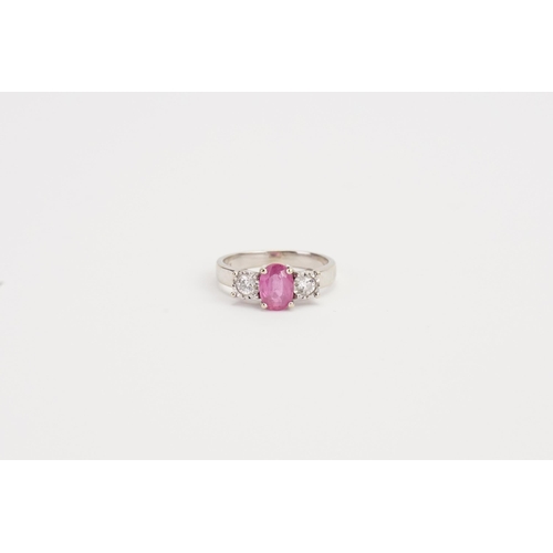 210 - A 18ct white Gold Pink Sapphire and Diamond ring, set with a 7.13mm x 5.20mm oval cut pink Sapphire.... 