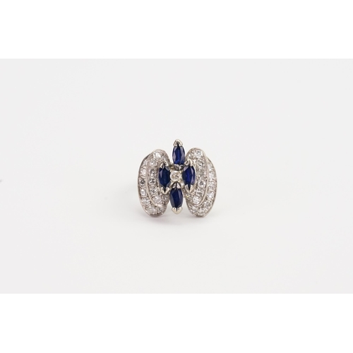 212 - A 18ct white Gold Diamond and Sapphire raised design ring. Set with four Sapphires and 31 Diamonds 0... 