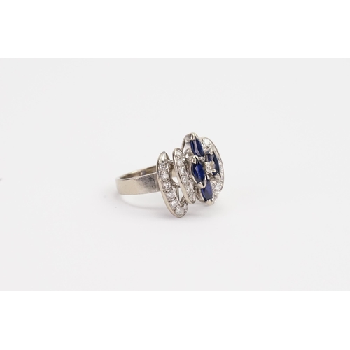 212 - A 18ct white Gold Diamond and Sapphire raised design ring. Set with four Sapphires and 31 Diamonds 0... 