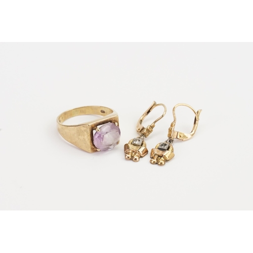 215 - A 9ct Gold Amethyst set dress ring. Size 9.6mm x 9.7mm. Size P. Weight 4.7g. Along with a pair of ea... 