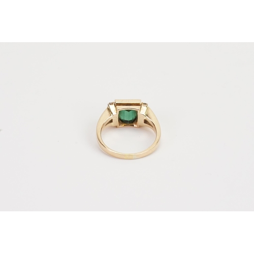 216 - A 18ct Dimond and Emerald ring. Size of Emerald 6mm x 6mm. Weight 5.7g. Size M.