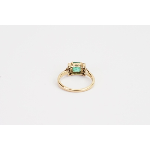 217 - A 18ct Emerald and Diamond set ring, set with 6 chip stones. Size of Emerald 5.3mm x 5.9mm. Ring siz... 