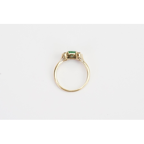 217 - A 18ct Emerald and Diamond set ring, set with 6 chip stones. Size of Emerald 5.3mm x 5.9mm. Ring siz... 