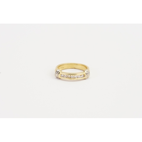 122 - A ladies 18ct Gold wedding band, set with 7 Diamonds. Weight 4.7g. Size M.