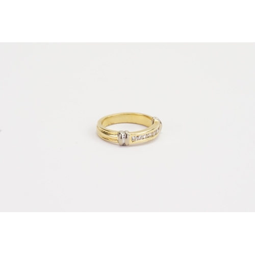 122 - A ladies 18ct Gold wedding band, set with 7 Diamonds. Weight 4.7g. Size M.