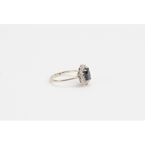 187 - An 18ct Gold Diamond and Sapphire set Ring set with an approximate 1ct oval Sapphire and 14 diamonds... 