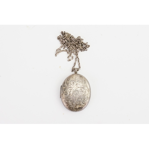 189 - A English hallmarked Silver Locket on a Chain with Silver decoration.