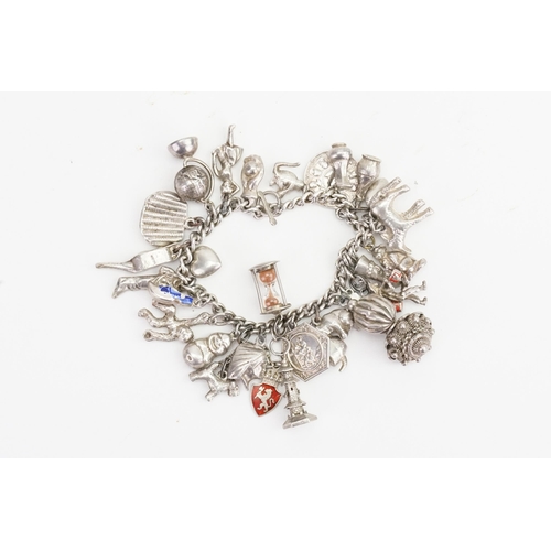 190 - A Silver Charm Bracelet with various charms.