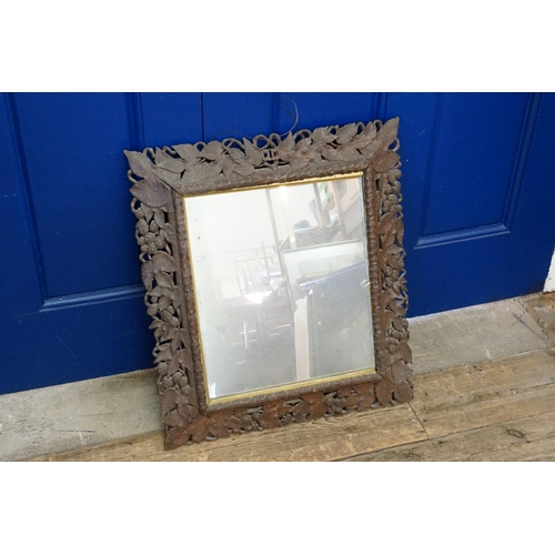 822 - A Bavarian Black Forest Carved Wooden Framed Mirror. Measuring: 51cms x 58cms.