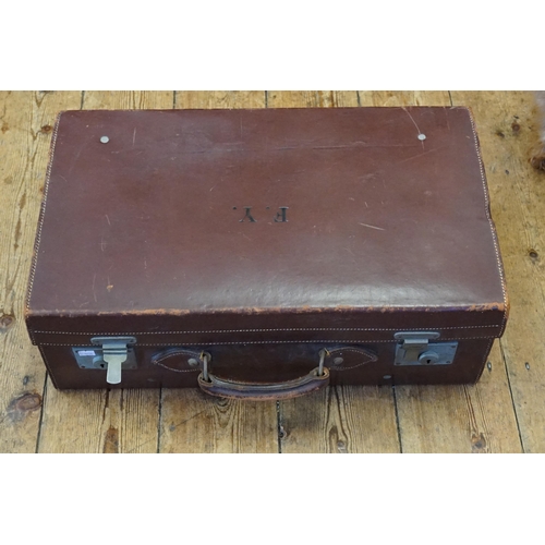 1035 - A Leather Stitched Suitcase with nickel silvered locks and cream cloth interior.