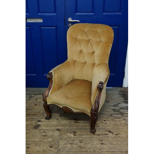 651A - A Gentleman's Walnut Framed Button Backed Occasional Chair with Wooden Arms and Shaped Feet.