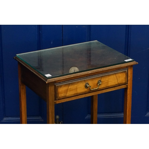 609 - A Mahogany & Walnut Veneered Single Drawer Lamp Table with a Glass Top. Measuring: 69cms high x 36cm... 