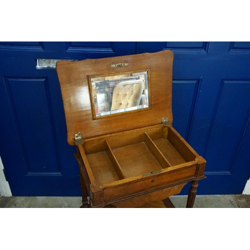 611 - A late 19th Century Beech & Mahogany Needlework Table resting on turned Swept out legs & a Fitted in... 