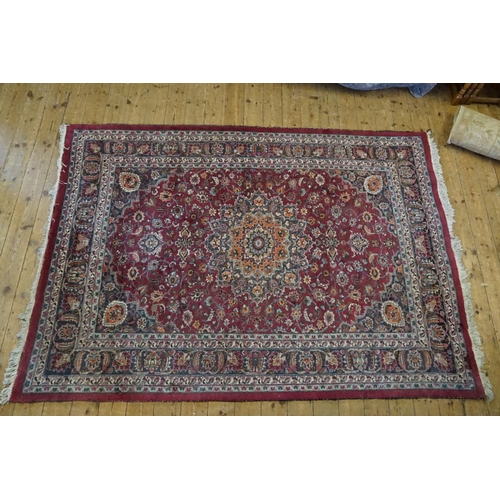 665 - A Burgundy Ground Cream & Blue Bordered Central Medallion Gul decorated Rug. Measuring: 300cms x 215... 