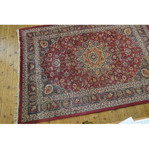 665 - A Burgundy Ground Cream & Blue Bordered Central Medallion Gul decorated Rug. Measuring: 300cms x 215... 