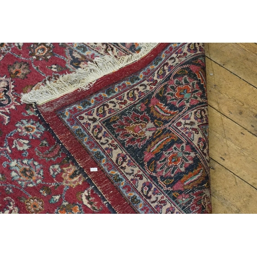 665 - A Burgundy Ground Cream & Blue Bordered Central Medallion Gul decorated Rug. Measuring: 300cms x 215... 